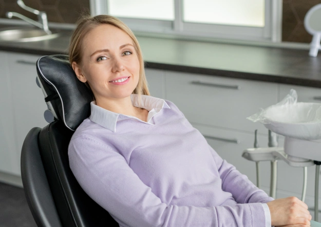 Smiling woman relaxing in a dental chair before her appointment